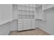 Walk-in closet featuring custom shelving, drawers and hanging rods at 10988 Wonder Hills St, Las Vegas, NV 89141