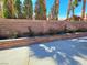 A block wall with some flowers and trees in the backyard at 1163 Spanish Armada Rd, Las Vegas, NV 89123