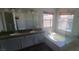 Primary bathroom with double sink vanity, soaking tub, and glass enclosed shower at 1163 Spanish Armada Rd, Las Vegas, NV 89123