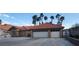 Single-story home showcasing a terra cotta roof, three car garage, long driveway, and desert landscaping at 1163 Spanish Armada Rd, Las Vegas, NV 89123