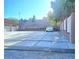 Spacious driveway and garage with manicured landscaping and a decorative fence at 1163 Spanish Armada Rd, Las Vegas, NV 89123