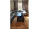 Comfortable living room featuring hardwood floors, a sectional sofa, and a lift top wooden coffee table at 1163 Spanish Armada Rd, Las Vegas, NV 89123