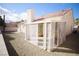 Home exterior showcasing a covered patio with lattice accents and a gravel-landscaped yard at 1171 Middleriver Ct, Las Vegas, NV 89123