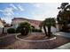 Beautifully landscaped front yard with desert accents, complemented by a charming single-story house at 1171 Middleriver Ct, Las Vegas, NV 89123