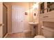 Well-lit bathroom featuring a pedestal sink, tiled floor, and a glass-enclosed shower stall at 1313 Gallery Oaks Dr, Las Vegas, NV 89123