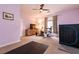 Bedroom with purple walls, ceiling fan, carpeted floors, home gym equipment, and a TV at 1313 Gallery Oaks Dr, Las Vegas, NV 89123