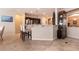 Open kitchen with breakfast bar, stainless steel appliances, dark wood cabinetry and tiled floors at 1313 Gallery Oaks Dr, Las Vegas, NV 89123
