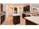 Elegant kitchen featuring an island, tile backsplash, stainless appliances, and dark cabinetry at 1313 Gallery Oaks Dr, Las Vegas, NV 89123