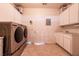 Laundry room featuring side by side washer and dryer, overhead cabinets and a utility sink at 1313 Gallery Oaks Dr, Las Vegas, NV 89123