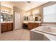 Beautiful bathroom with double sinks, bathtub, tile floor, and vanity area at 1313 Gallery Oaks Dr, Las Vegas, NV 89123