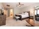 Spacious main bedroom featuring textured wall, ceiling fan, neutral carpet and furnishings at 1313 Gallery Oaks Dr, Las Vegas, NV 89123