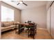 Bright office with a ceiling fan, wood floors, a desk with storage and a comfortable couch by the window at 1313 Gallery Oaks Dr, Las Vegas, NV 89123