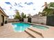 Backyard pool with spa, palm trees and decorative water feature, set within a private backyard at 1313 Gallery Oaks Dr, Las Vegas, NV 89123