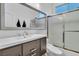 Well-lit bathroom featuring a modern vanity, sink, and shower with glass doors at 1486 Neyland Dr, Henderson, NV 89012