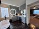 Chic bathroom boasts modern vanities, glass block window, and a luxurious soaking tub at 1486 Neyland Dr, Henderson, NV 89012