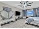 Comfortable bedroom features large window, ceiling fan, and unique seating area at 1486 Neyland Dr, Henderson, NV 89012