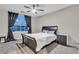 Cozy bedroom with a large window, ceiling fan, and carpet at 1486 Neyland Dr, Henderson, NV 89012