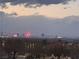 Las Vegas city skyline at dusk, showcasing iconic hotels and buildings with vibrant lights and a cloudy sky above at 1486 Neyland Dr, Henderson, NV 89012