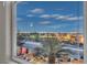 Stunning Las Vegas city view from a large window overlooking palm trees and surrounding neighborhood at twilight at 1486 Neyland Dr, Henderson, NV 89012