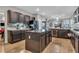 Modern kitchen featuring dark cabinets, stainless steel appliances, and a center island at 1486 Neyland Dr, Henderson, NV 89012