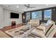 Spacious living room with hardwood floors, large windows, and modern furnishings at 1486 Neyland Dr, Henderson, NV 89012