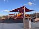 Modern playground area with slides, climbing structures, and covered shade, perfect for outdoor activities at 1486 Neyland Dr, Henderson, NV 89012
