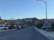 Street view showcasing the homes on the block and the mountain view in the distance at 1486 Neyland Dr, Henderson, NV 89012