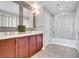 This bathroom has a double sink vanity with wood cabinets, white countertops and a shower and tub combo at 150 Las Vegas Blvd # 1711, Las Vegas, NV 89101
