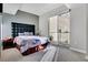 Bright bedroom features a soft color palette, carpet flooring, a sliding glass door and a black upholstered headboard at 150 Las Vegas Blvd # 1711, Las Vegas, NV 89101