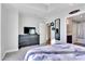 This bedroom has carpet flooring, a large dresser with a TV, closet, and access to the bathroom at 150 Las Vegas Blvd # 1711, Las Vegas, NV 89101
