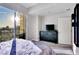 This bedroom features views of the city, an exterior balcony, carpet flooring and a large dresser with a TV at 150 Las Vegas Blvd # 1711, Las Vegas, NV 89101