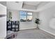 Open-concept room with a floor-to-ceiling window showing city views, a bookshelf, and potted plants at 150 Las Vegas Blvd # 1711, Las Vegas, NV 89101