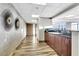 Hallway with wood floors, designer lighting, and built-in bar area, leading to a bright space with city views at 150 Las Vegas Blvd # 1711, Las Vegas, NV 89101