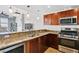 Modern kitchen with granite countertops, stainless steel appliances, and wood cabinets at 150 Las Vegas Blvd # 1711, Las Vegas, NV 89101