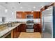 Well-lit kitchen with stainless steel appliances, wooden cabinetry, and granite countertops at 150 Las Vegas Blvd # 1711, Las Vegas, NV 89101