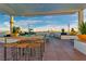 Stunning rooftop deck boasting stylish outdoor furniture, a covered dining space, and a panoramic cityscape backdrop at 150 Las Vegas Blvd # 1711, Las Vegas, NV 89101