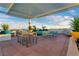 Outdoor living at its finest on this rooftop deck with lounge seating, dining area, and scenic city views at 150 Las Vegas Blvd # 1711, Las Vegas, NV 89101