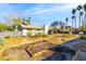 Expansive backyard with gardening beds surrounding the home and mature palm trees in the distance at 1513 Kirkland Ave, Las Vegas, NV 89102