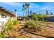 Picturesque backyard featuring desert landscaping, winding paths, and lush greenery, creating a serene outdoor oasis at 1513 Kirkland Ave, Las Vegas, NV 89102