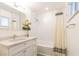 Bright bathroom featuring a vanity with a modern countertop, and a shower-tub combination with a clean, white tile surround at 1513 Kirkland Ave, Las Vegas, NV 89102