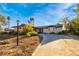 Charming single-story home featuring a long driveway and desert landscaping, with palm trees visible in the background at 1513 Kirkland Ave, Las Vegas, NV 89102