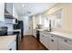 Modern kitchen with stainless steel appliances, a large window and white cabinetry at 1513 Kirkland Ave, Las Vegas, NV 89102