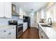 Modern kitchen with stainless steel appliances, white cabinets, and sleek countertops at 1513 Kirkland Ave, Las Vegas, NV 89102