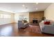 Inviting living room with a brick fireplace, wood floors, neutral paint, and comfortable seating creating a cozy atmosphere at 1513 Kirkland Ave, Las Vegas, NV 89102