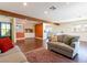 Spacious living room with exposed beams, hardwood floors, comfortable seating, and open access to adjacent dining and kitchen areas at 1513 Kirkland Ave, Las Vegas, NV 89102