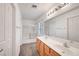 Bright bathroom with double sink vanity, large mirror, and a shower over tub at 1552 Wild Willey Way, Henderson, NV 89002