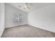 This bedroom is spacious and bright, featuring neutral carpet and a ceiling fan at 1552 Wild Willey Way, Henderson, NV 89002