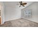 Simple bedroom with neutral carpet, ceiling fan, and a bright window at 1552 Wild Willey Way, Henderson, NV 89002