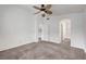 Bright bedroom with a ceiling fan and doorways to the bathroom and closet at 1552 Wild Willey Way, Henderson, NV 89002