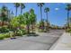 Gated community entrance with manicured landscaping, mature trees and lush greenery at 1552 Wild Willey Way, Henderson, NV 89002